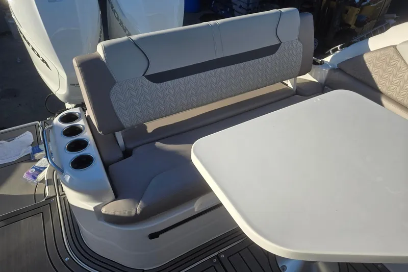 Slide: The Image of 2026 Hurricane SunDeck 3200 OB boat interior with seating and table, featuring cup holders. - 74