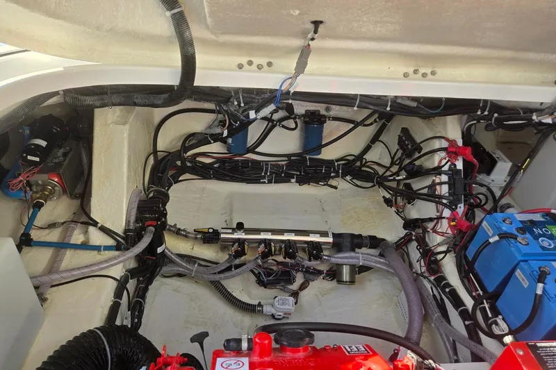 Slide: The Image of Engine compartment of 2026 Hurricane SunDeck 3200 OB with wiring and components visible. - 77