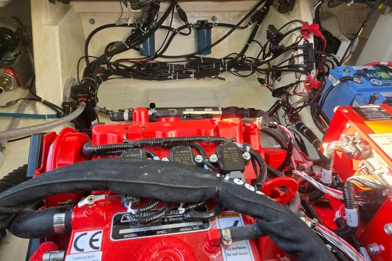 Slide: The Image of Engine compartment of 2026 Hurricane SunDeck 3200 OB with visible wiring and components. - 80