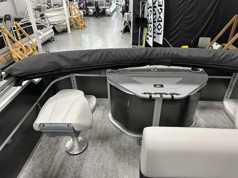 Slide: The Image of 2025 South Bay 222FCR LE pontoon boat interior with seating and console in showroom. - 17