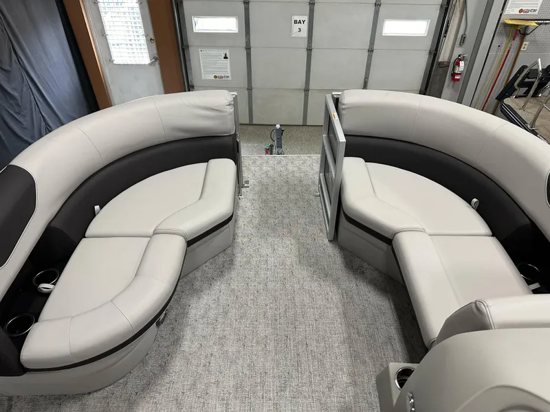 Slide: The Image of 2025 South Bay 222FCR LE pontoon boat interior with plush seating and cup holders. - 8