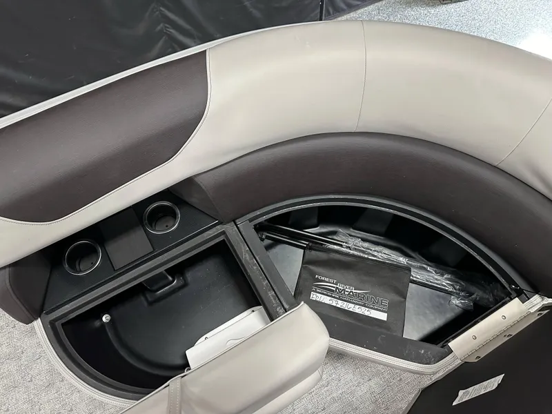 Slide: The Image of 2025 South Bay 222FCR LE boat interior with storage compartment and cup holders. - 9