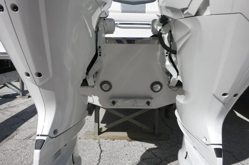Slide: The Image of 2025 Chaparral 280 OSX Bowrider, rear view of dual outboard engines. - 13