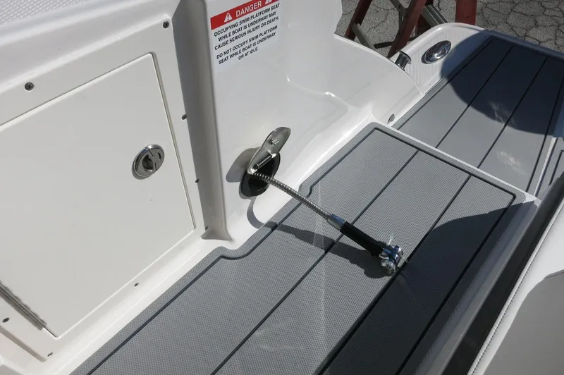 Slide: The Image of 2025 Chaparral 280 OSX Bowrider deck with safety features and storage compartment. - 20