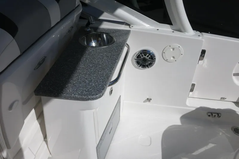 Slide: The Image of 2025 Chaparral 280 OSX Bowrider interior with sink and countertop detail. - 22