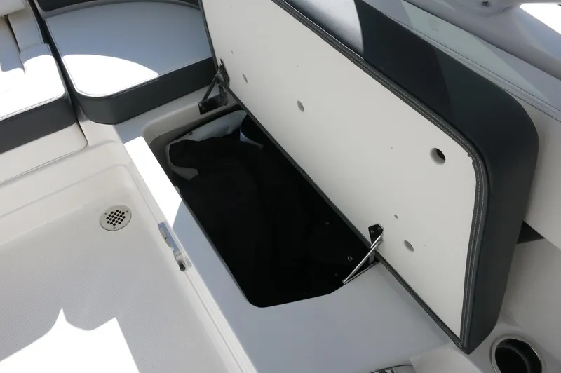 Slide: The Image of 2025 Chaparral 280 OSX Bowrider storage compartment, open with visible interior space. - 27