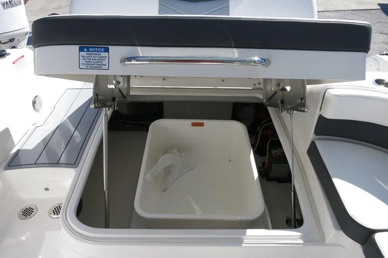Slide: The Image of 2025 Chaparral 280 OSX Bowrider storage compartment with open lid and interior view. - 28