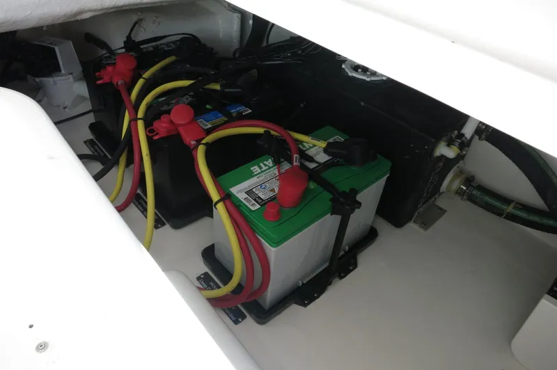 Slide: The Image of Battery compartment of 2025 Chaparral 280 OSX Bowrider with connected cables. - 29