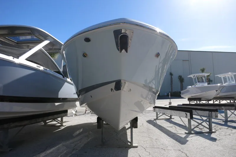 Slide: The Image of 2025 Chaparral 280 OSX Bowrider boat displayed outdoors on a sunny day. - 3