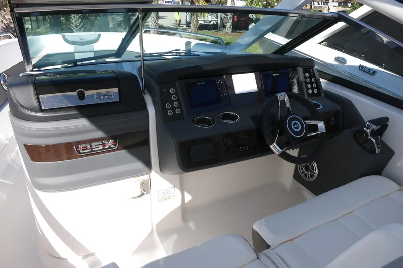 Slide: The Image of 2025 Chaparral 280 OSX Bowrider dashboard with modern controls and steering wheel. - 34