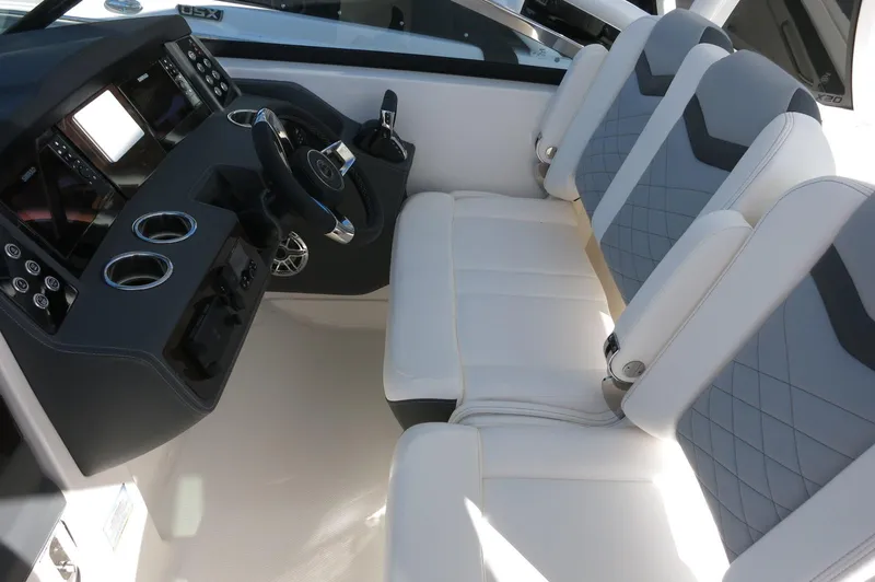 Slide: The Image of 2025 Chaparral 280 OSX Bowrider cockpit with modern seating and control panel. - 35