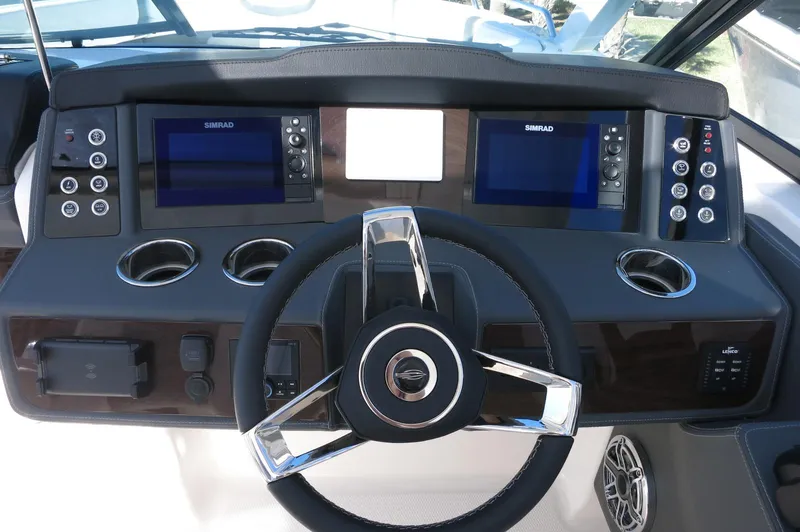 Slide: The Image of 2025 Chaparral 280 OSX Bowrider dashboard with dual Simrad displays and modern steering wheel. - 37