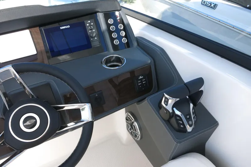 Slide: The Image of 2025 Chaparral 280 OSX Bowrider dashboard with steering wheel and control panel. - 38