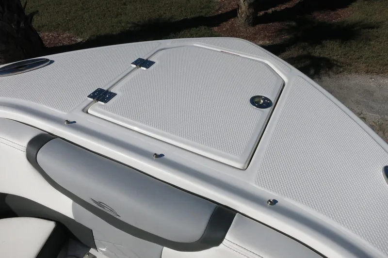 Slide: The Image of 2025 Chaparral 280 OSX Bowrider, white deck with storage compartment, sleek design. - 44