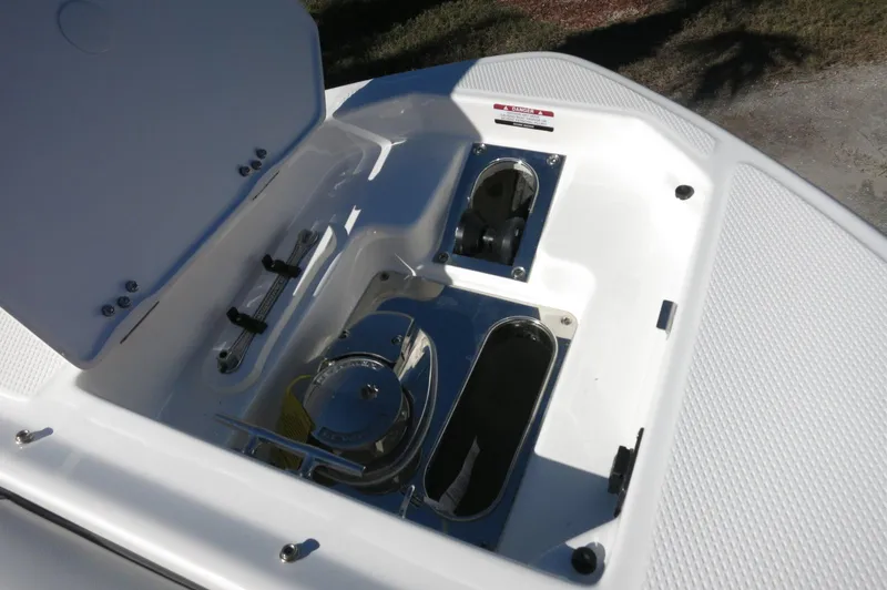 Slide: The Image of 2025 Chaparral 280 OSX Bowrider anchor compartment with open hatch, showcasing storage features. - 45
