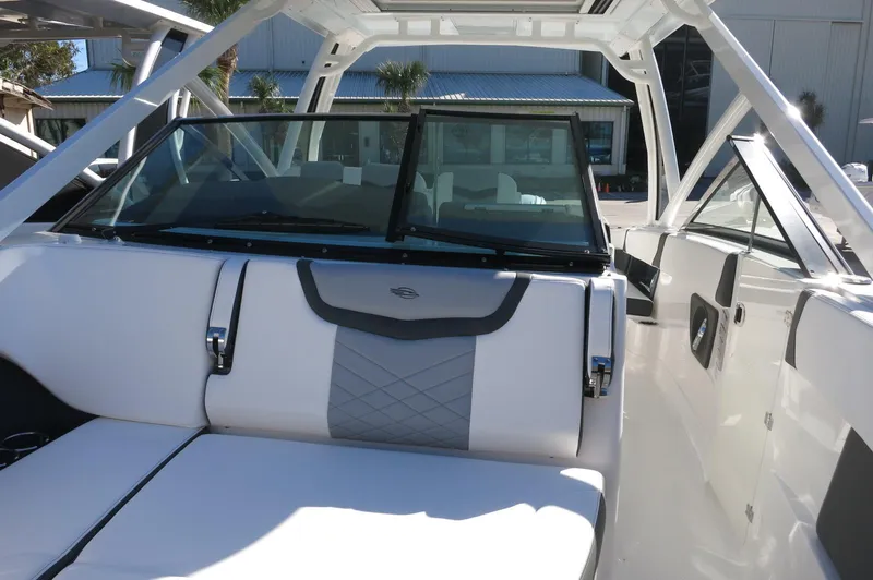 Slide: The Image of 2025 Chaparral 280 OSX Bowrider interior with white seating and modern design. - 47