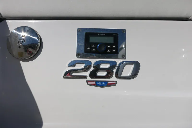 Slide: The Image of 2025 Chaparral 280 OSX Bowrider dashboard with control panel and model emblem. - 7