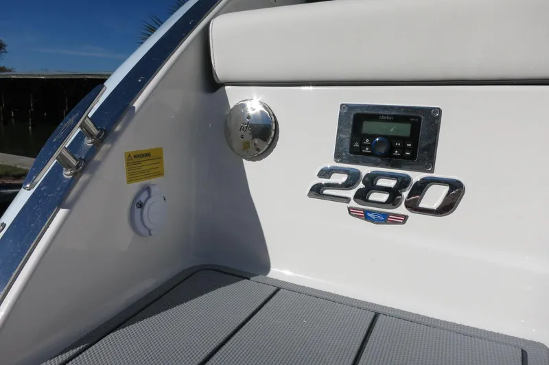 Slide: The Image of 2025 Chaparral 280 OSX Bowrider interior detail with model emblem and control panel. - 8