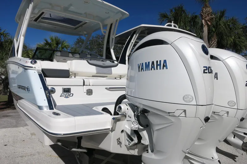 Slide: The Image of 2025 Chaparral 280 OSX Bowrider with Yamaha engines, docked outdoors. - 9