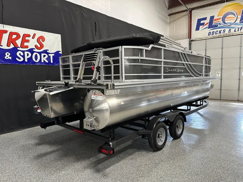 Slide: The Image of 2025 South Bay 222FCR LE 2.75 pontoon boat on trailer in showroom. - 1