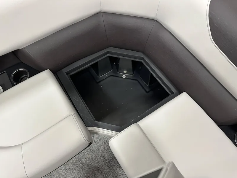 Slide: The Image of Interior of 2025 South Bay 222FCR LE 2.75 boat with cup holders and storage compartment. - 14