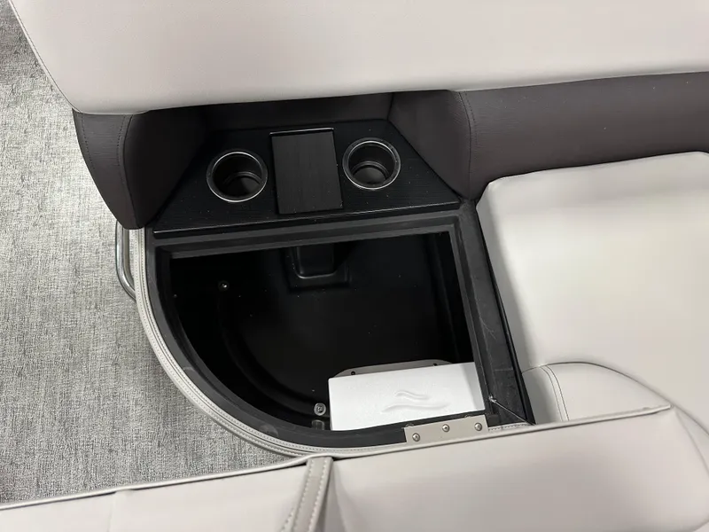 Slide: The Image of 2025 South Bay 222FCR LE 2.75 pontoon boat interior in showroom, featuring seating and helm. - 15
