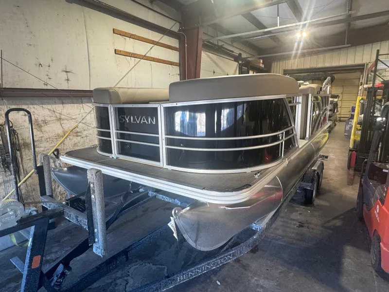 The Image of 2025 Sylvan Mirage 8520 Cruise pontoon boat in a warehouse setting. - 0
