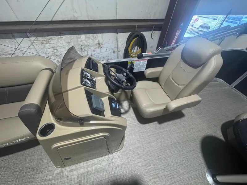 Slide: The Image of 2025 Sylvan Mirage 8520 Cruise boat interior with beige captain's chair and control panel. - 5