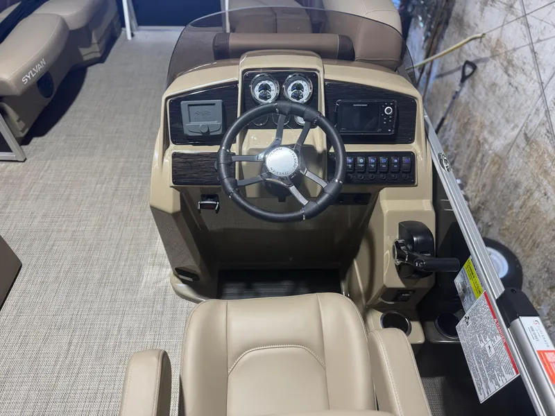 Slide: The Image of 2025 Sylvan Mirage 8520 Cruise boat dashboard with steering wheel and control panel. - 6