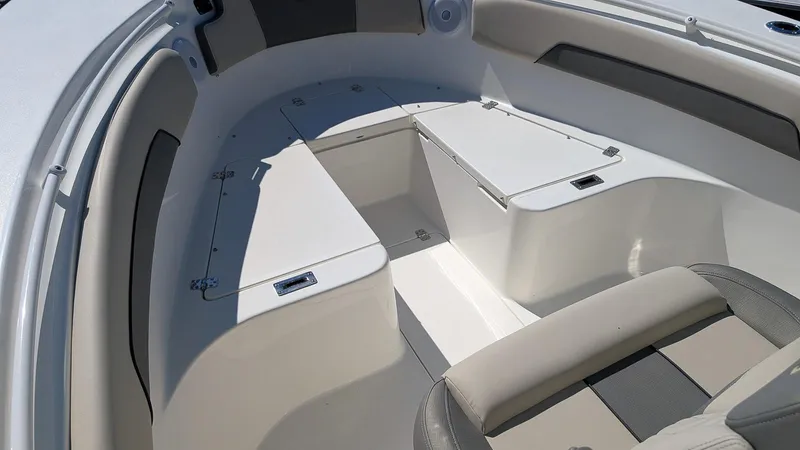 Slide: The Image of 2025 Key West 260 CC boat interior with cushioned seating and storage compartments. - 15