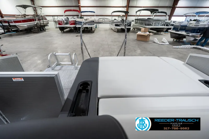 Slide: The Image of 2025 Bennington 22 SSB pontoon boat in showroom with other boats in background. - 18