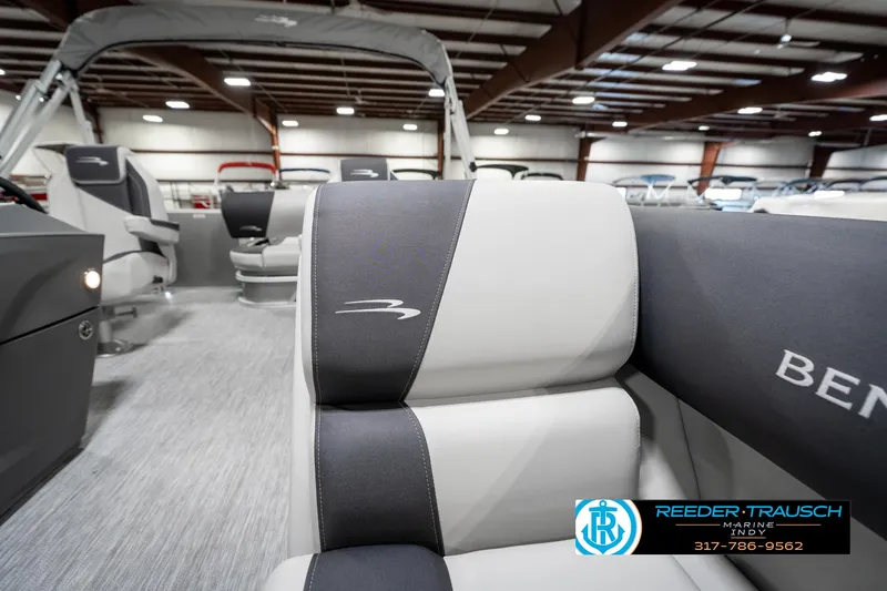 Slide: The Image of 2025 Bennington 22 SSB boat interior with gray and white seating in showroom. - 24