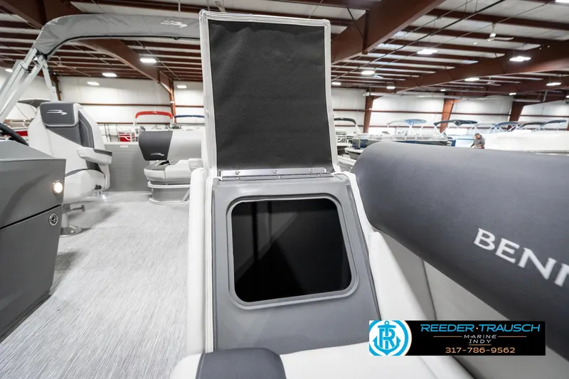 Slide: The Image of 2025 Bennington 22 SSB boat interior with open storage compartment in showroom. - 25