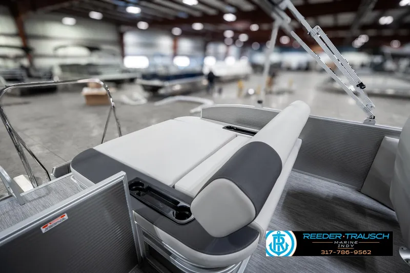 Slide: The Image of 2025 Bennington 22 SSB boat interior with sleek seating in a showroom setting. - 26