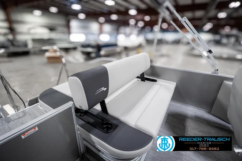 Slide: The Image of 2025 Bennington 22 SSB boat interior with gray seating in a showroom. - 28