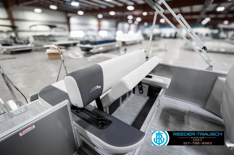 Slide: The Image of 2025 Bennington 22 SSB boat interior with sleek seating in a showroom. - 29