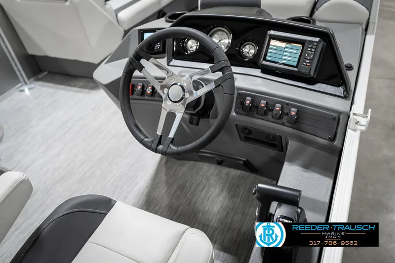 Slide: The Image of 2025 Bennington 22 SSB boat dashboard with steering wheel and control panel. - 30