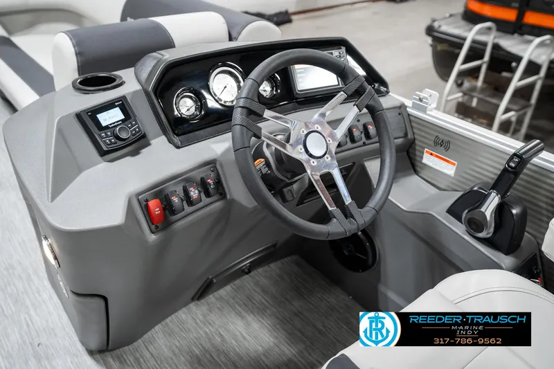 Slide: The Image of 2025 Bennington 22 SSB boat dashboard with steering wheel and control panel. - 31