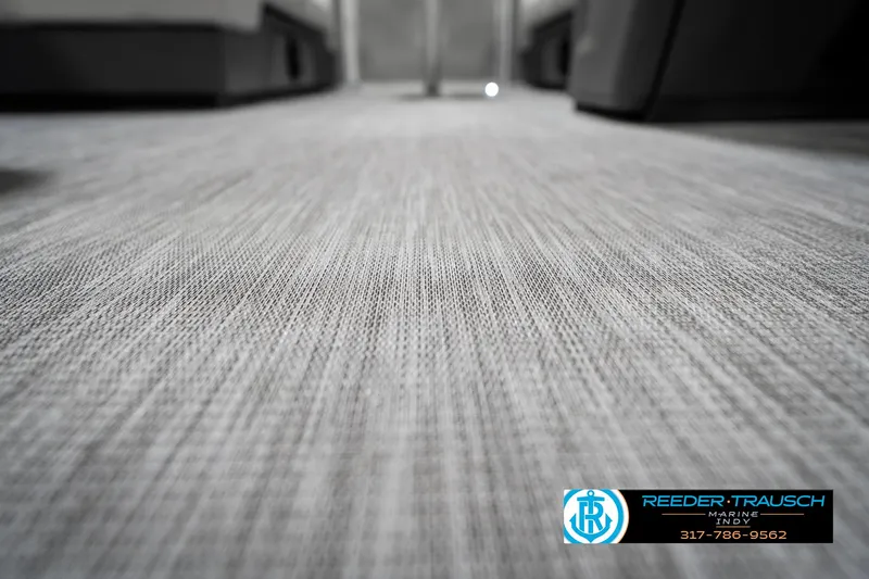 Slide: The Image of 2025 Bennington 22 SSB interior flooring with textured design, featuring Reeder-Trausch Marine branding. - 48
