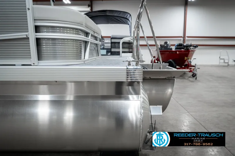 Slide: The Image of 2025 Bennington 22 SSB pontoon boat in showroom, side view, metallic finish. - 49