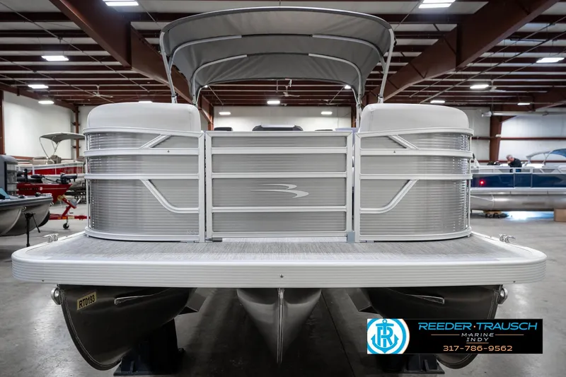 Slide: The Image of 2025 Bennington 22 SSB pontoon boat in showroom, front view with canopy. - 5