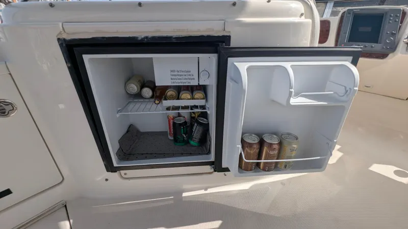 Slide: The Image of Open mini fridge on 2004 Meridian 408 Motor Yacht, stocked with beverages. - 10