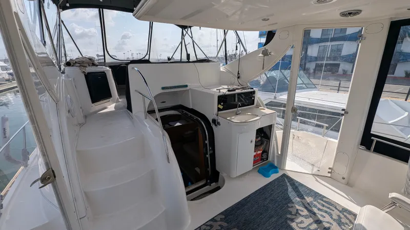 Slide: The Image of 2004 Meridian 408 Motor Yacht interior with stairs, helm, and seating area. - 12