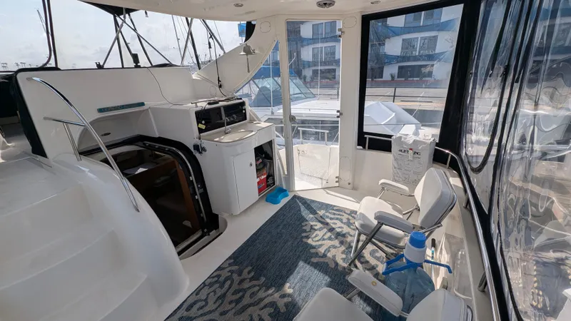 Slide: The Image of 2004 Meridian 408 Motor Yacht interior with seating, kitchenette, and modern amenities. - 13