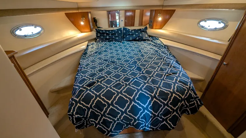 Slide: The Image of Luxurious bedroom in 2004 Meridian 408 Motor Yacht with patterned bedding and ambient lighting. - 14