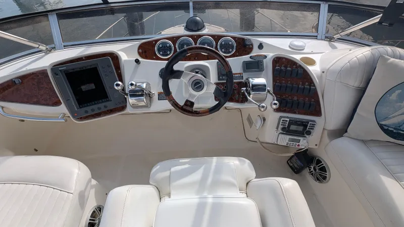 Slide: The Image of 2004 Meridian 408 Motor Yacht helm with steering wheel, controls, and navigation equipment. - 2