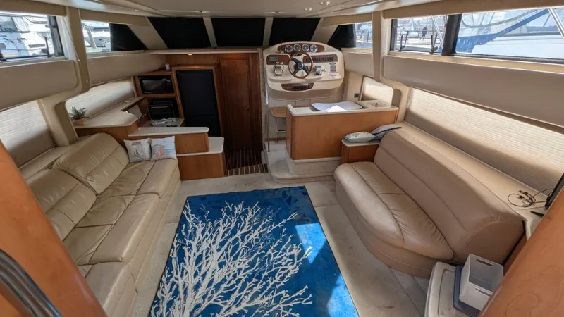 Slide: The Image of Interior of 2004 Meridian 408 Motor Yacht with beige seating and blue rug. - 23
