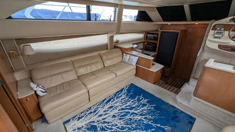 Slide: The Image of Luxurious interior of 2004 Meridian 408 Motor Yacht with beige sofa and blue rug. - 24