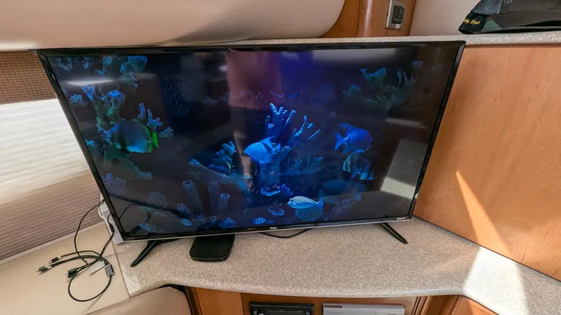 Slide: The Image of Flat-screen TV displaying an aquarium scene inside a 2004 Meridian 408 Motor Yacht. - 32