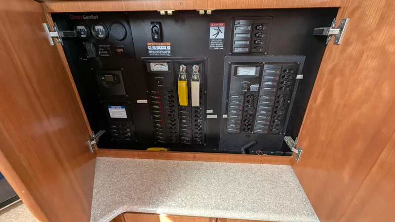 Slide: The Image of Electrical panel inside 2004 Meridian 408 Motor Yacht, featuring circuit breakers and controls. - 33